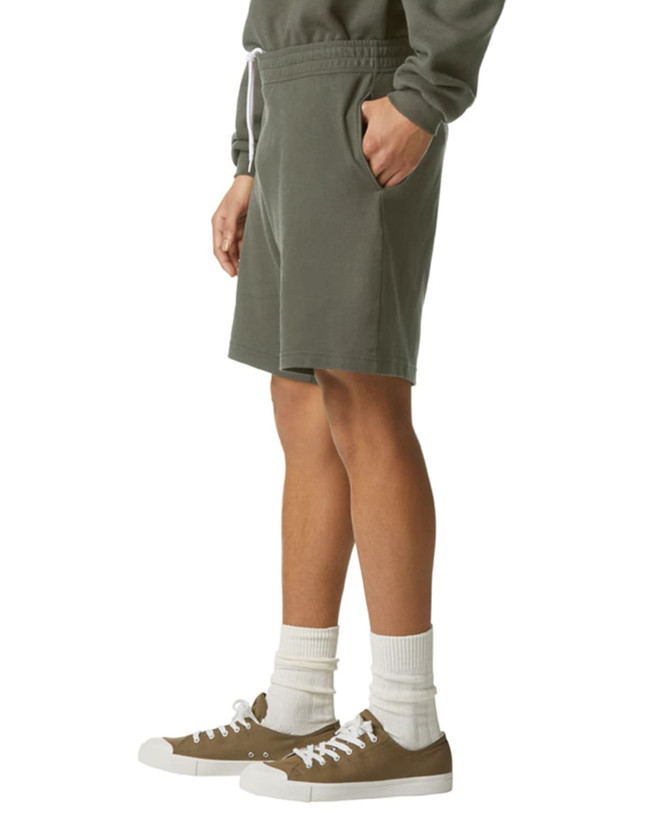 Unisex gym shorts in olive green, featuring a drawstring waist and side pockets, paired with casual shoes and socks.