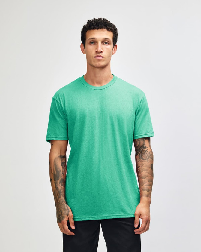 A solid mint green unisex short sleeve T-shirt on a model, featuring a logo on the chest.