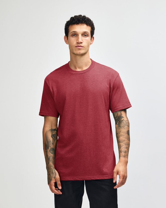 A unisex CVC short sleeve T-shirt in a rich burgundy colour, displayed on a model. Features a logo.