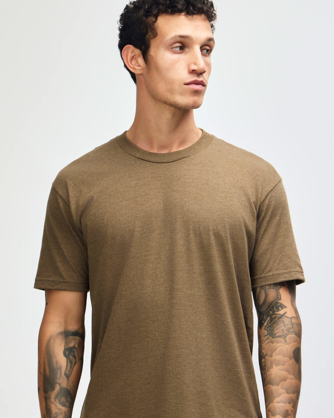A unisex short sleeve t-shirt in a muted brown colour, displayed on a model. Features a logo.
