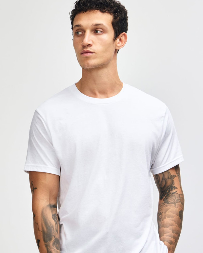 A unisex short sleeve T-shirt in white, featuring a simple design and a logo on the front.
