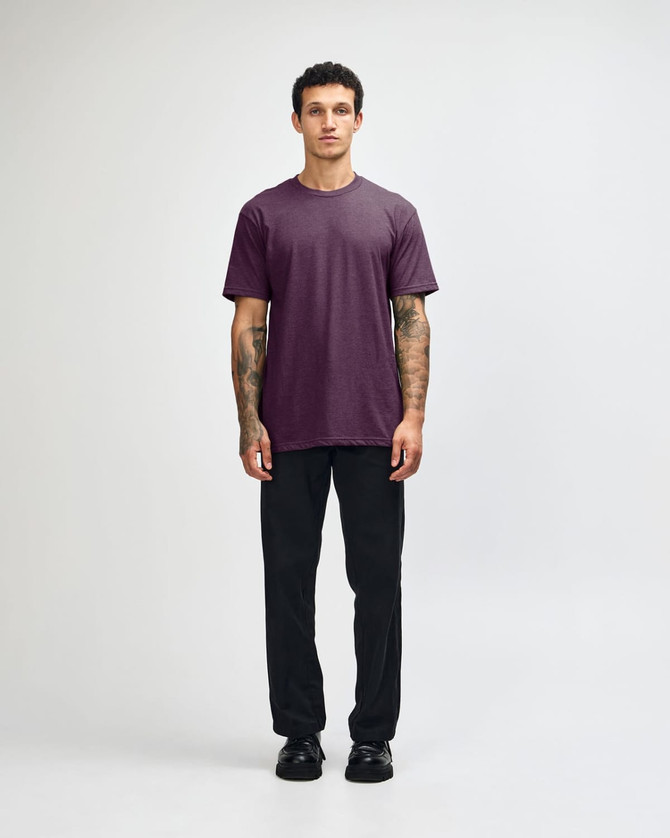A unisex short sleeve T-shirt in a deep purple colour, paired with black cargo pants, featuring a logo.