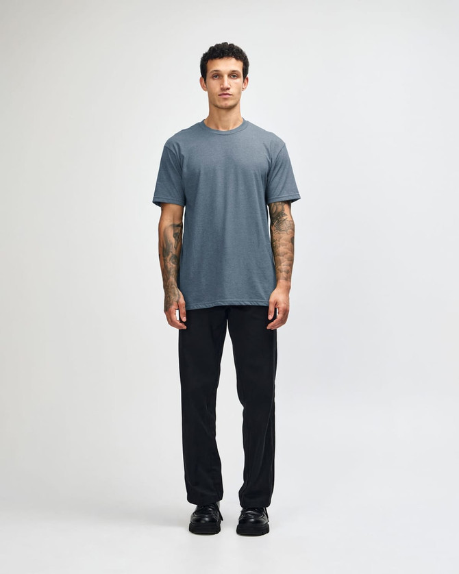 A short sleeve unisex t-shirt in a blue shade, paired with black cargo pants, featuring a logo.