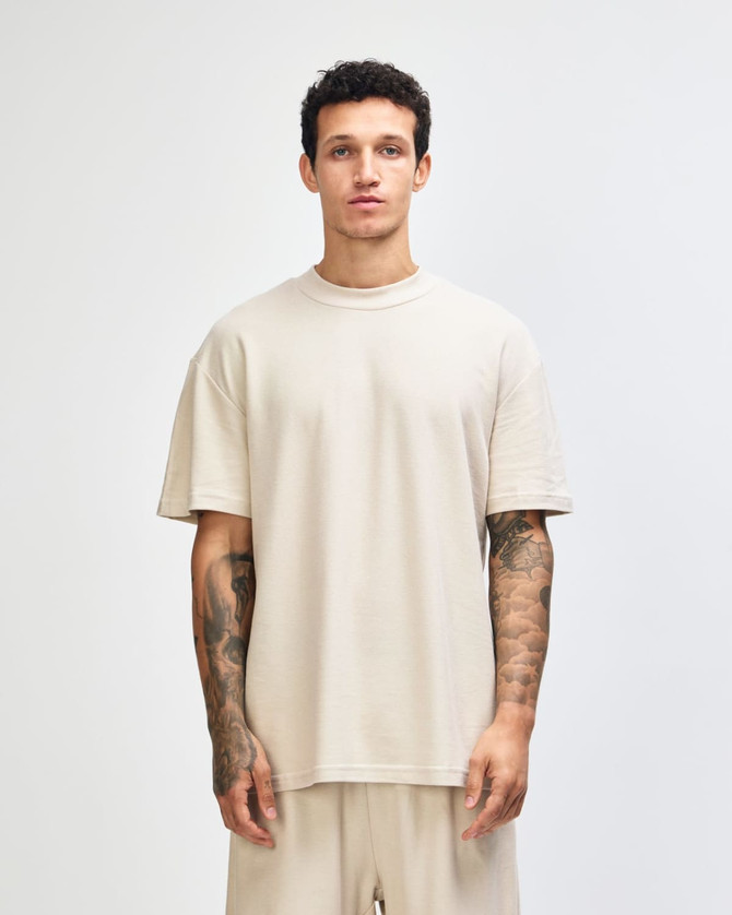 Unisex mockneck T-shirt in a neutral beige colour, featuring a relaxed fit and logo detail.