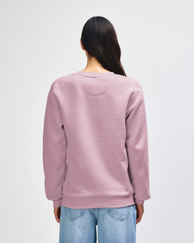 A unisex crewneck sweatshirt in a soft lavender colour, featuring a relaxed fit and long sleeves, with a logo present.