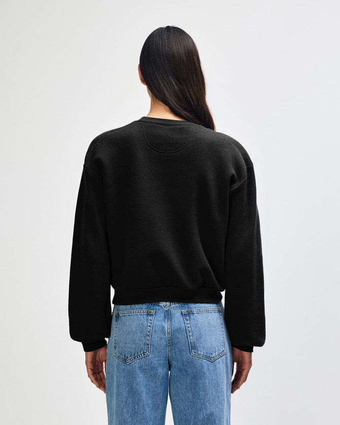 A black women's crewneck sweatshirt with a relaxed fit, viewed from the back. Features a logo on the garment.