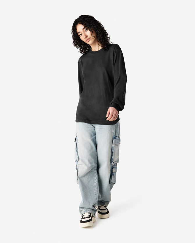 A black long sleeve T-shirt paired with light blue cargo pants, modelled by a person with curly hair.