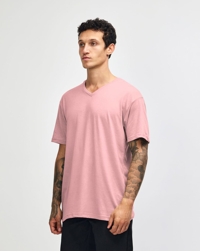 A unisex V-neck T-shirt in a soft pink colour, displayed from the side with a subtle logo.