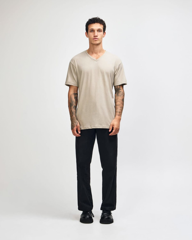 A beige unisex V-neck T-shirt, featuring a relaxed fit and short sleeves, with a branding logo present.