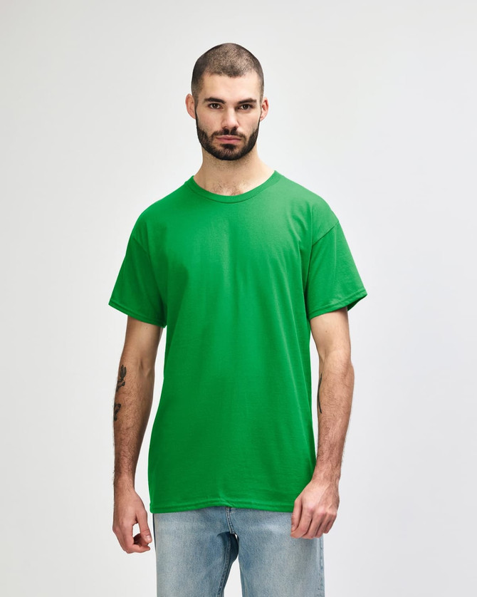 A green Gildan Heavy Cotton Adult T-Shirt displayed on a model against a neutral background.