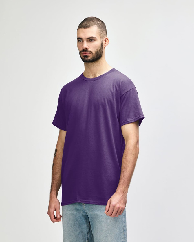 A purple Gildan Heavy Cotton adult T-shirt displayed on a model, featuring a blank design and no visible logos.
