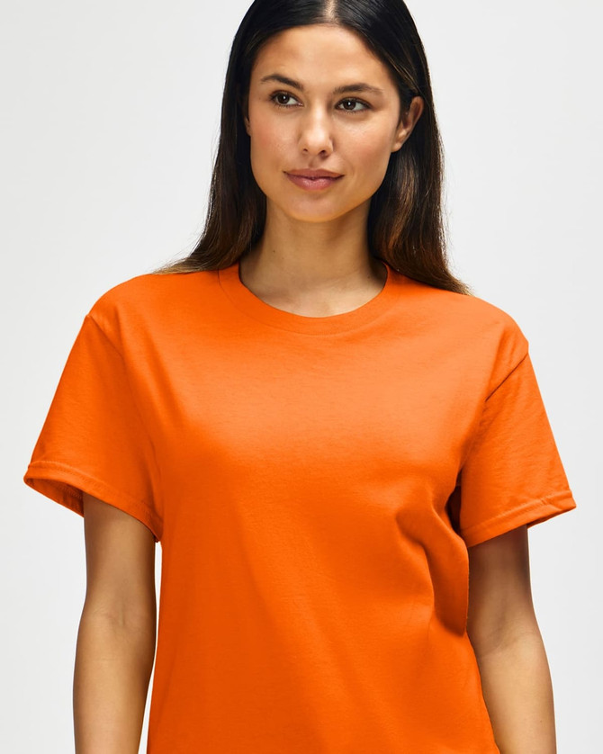 An orange Gildan Heavy Cotton adult T-shirt displayed on a model, featuring a classic fit and crew neckline.