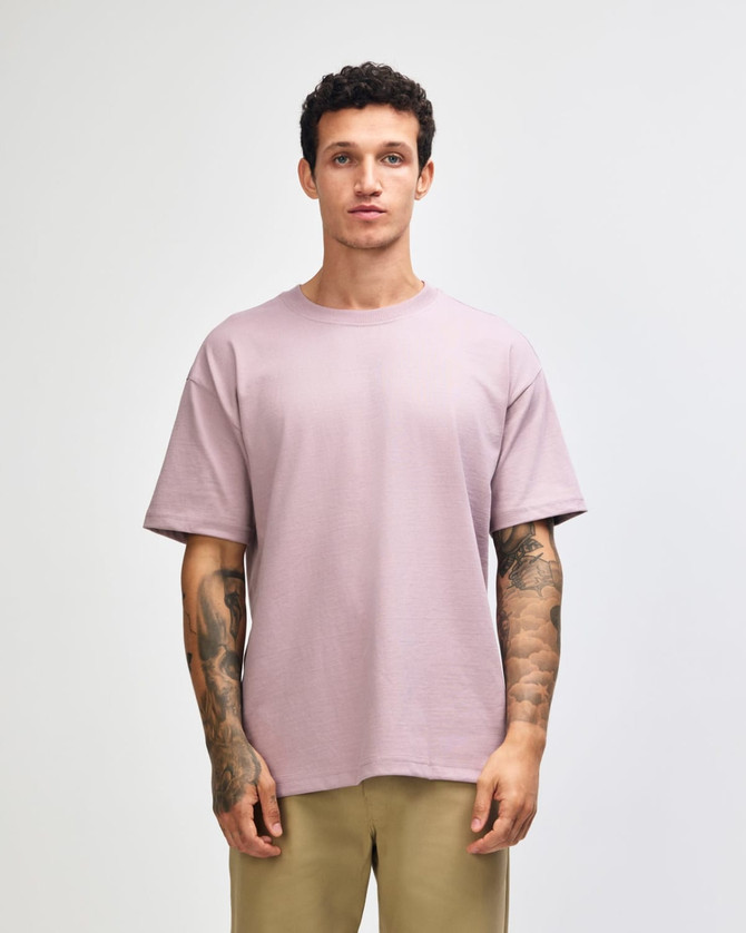 A model wearing a purple American Apparel Super Heavyweight T-Shirt, paired with olive green shorts.