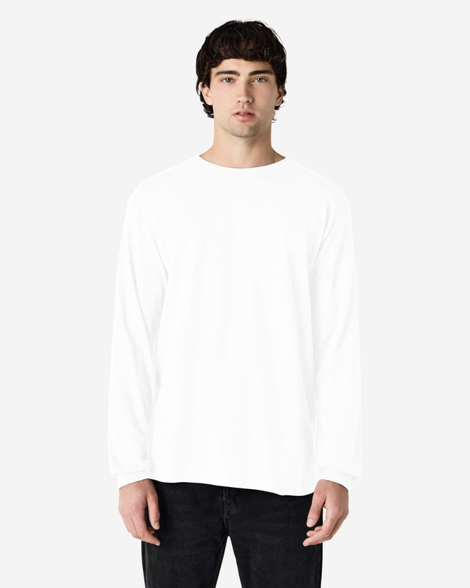 A white long sleeve t-shirt on a male model, featuring a logo on the chest.