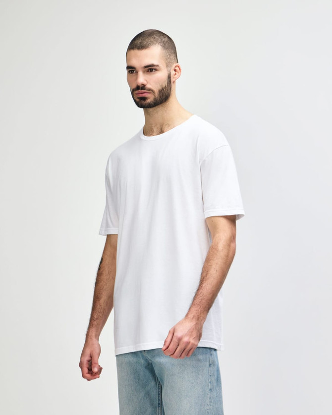A white Gildan Softstyle adult t-shirt displayed on a model, with a simple design and soft fabric texture.