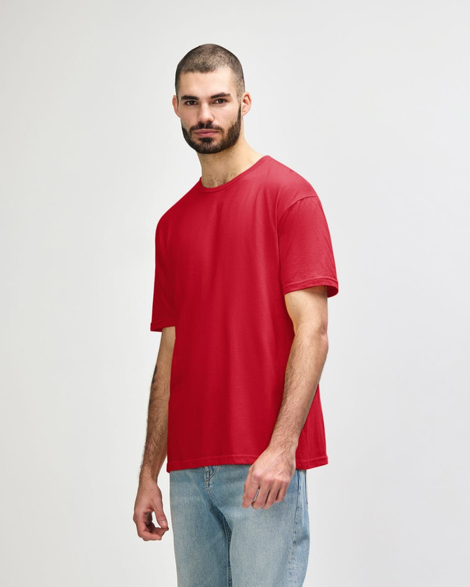A red Gildan Softstyle adult T-shirt is displayed on a model wearing blue jeans. The shirt features a logo.