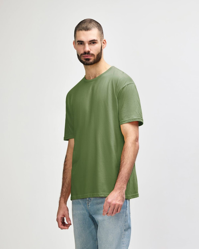 An olive green Gildan Softstyle adult t-shirt worn by a male model, featuring a simple design and a logo.