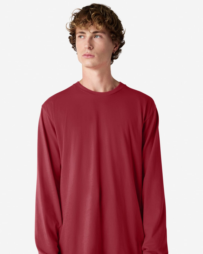 A long sleeve T-shirt in red, featuring a simple design and a crew neck. It includes a logo on the fabric.