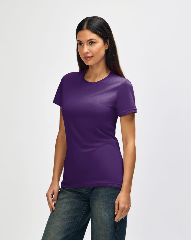 A Gildan Softstyle ladies' T-shirt in purple, featured on a model, displayed from the side with casual jeans.