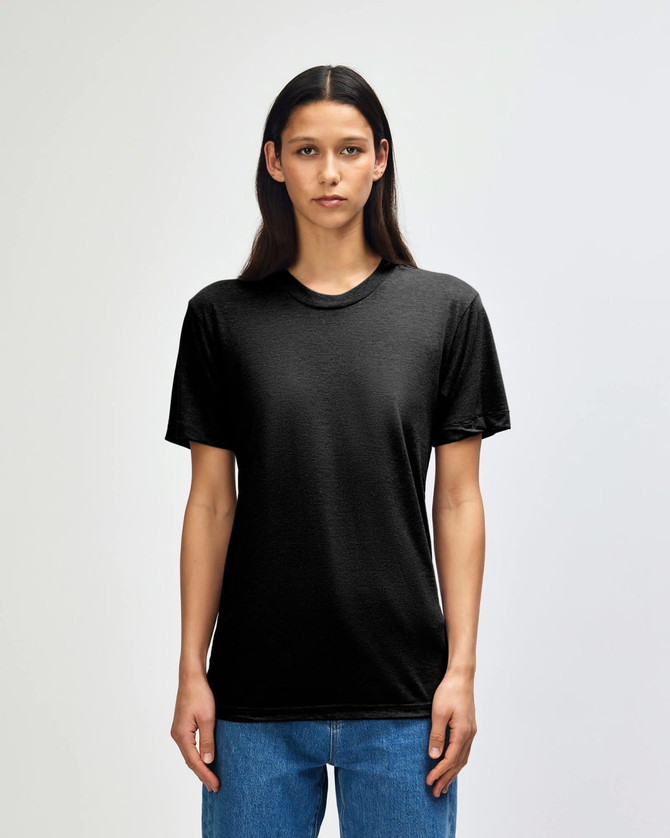 A black American Apparel tri-blend t-shirt worn by a model, featuring a simple design and a relaxed fit.