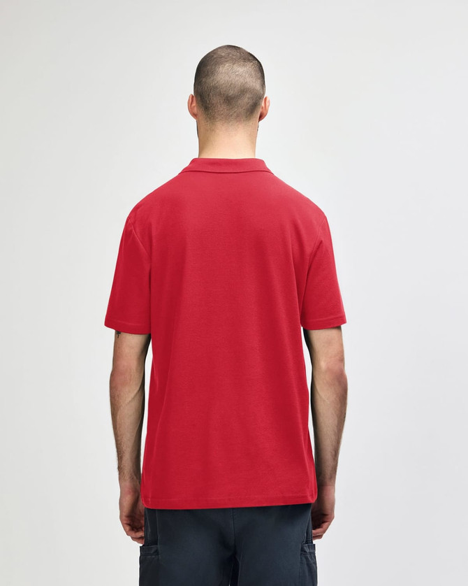 A red adult polo shirt with a collar and short sleeves, featuring a plain design and a logo on the back.
