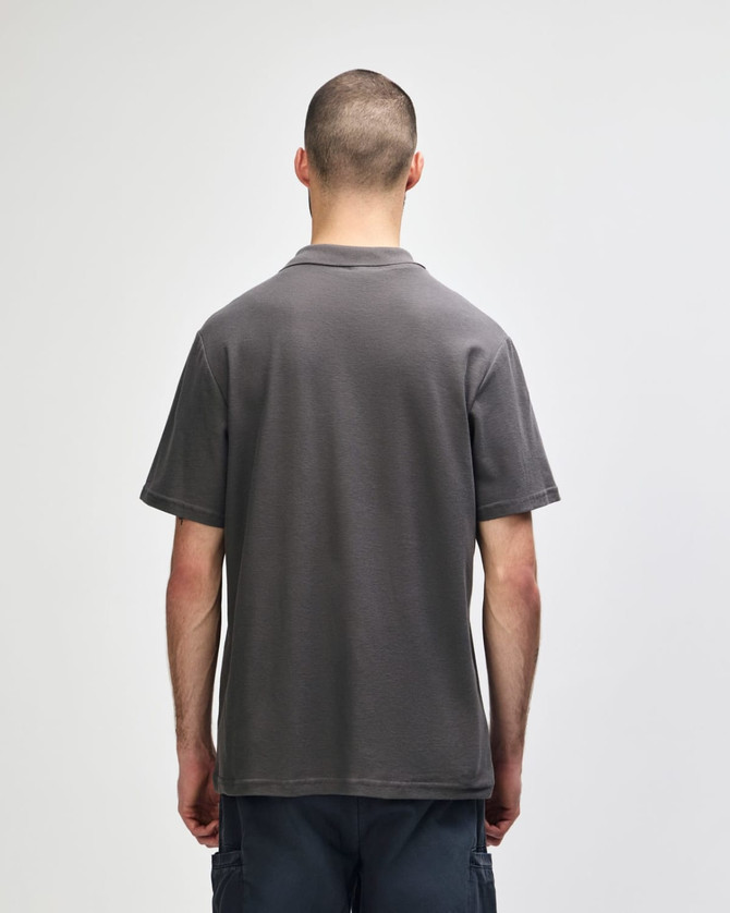 A grey Gildan Softstyle Adult Double Pique Polo displayed from the back. Features a logo on the collar area.