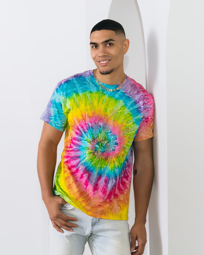 A multi-coloured tie dye adult T-shirt featuring vibrant swirls of blue, pink, yellow, and green. It has a logo.