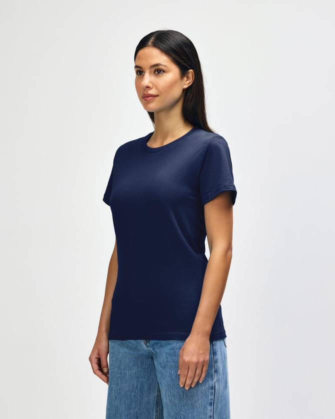 A navy Gildan Softstyle ladies midweight T-shirt displayed on a model, featuring a simple design and a logo.