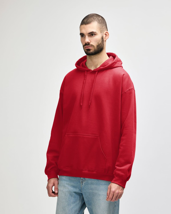 A red hooded sweatshirt displayed on a model, featuring a front pocket and a drawstring hood. It has a logo.