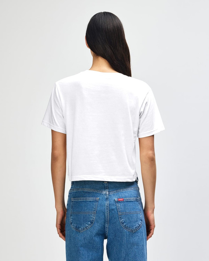A white women's boxy t-shirt from American Apparel, featuring a plain back, paired with denim jeans.