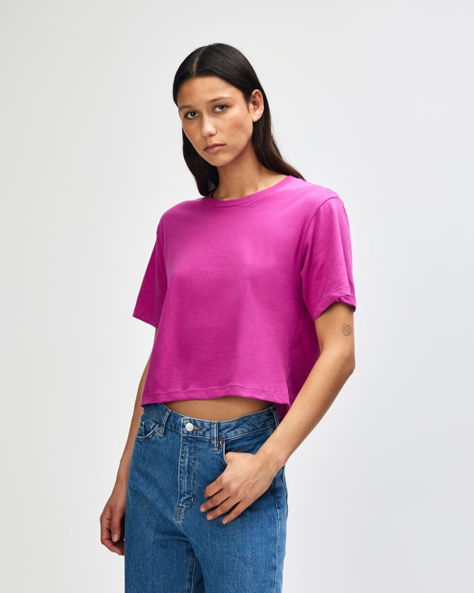 A women's fine jersey boxy t-shirt in vibrant pink, featuring short sleeves and relaxed fit. It has a logo.