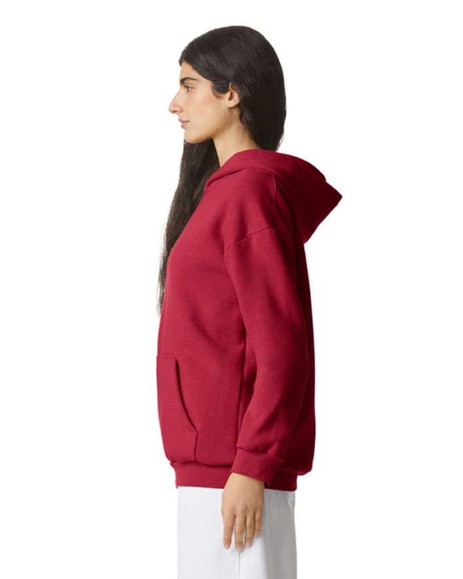 A unisex hooded sweatshirt in red, featuring a front pocket and a relaxed fit. It has a logo on the front.