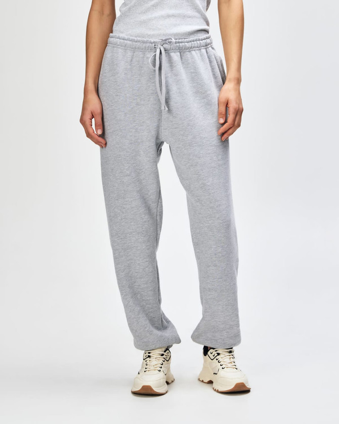 Grey unisex sweatpants with an elastic waistband and cuffs, featuring side pockets and a logo.