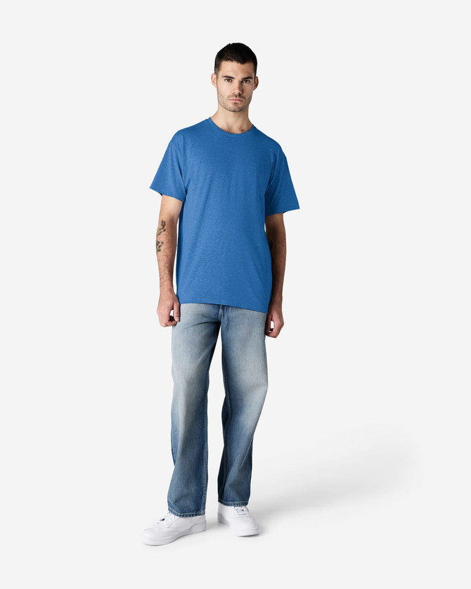 A blue Gildan Light Cotton T-Shirt displayed on a model wearing light denim jeans and white shoes.