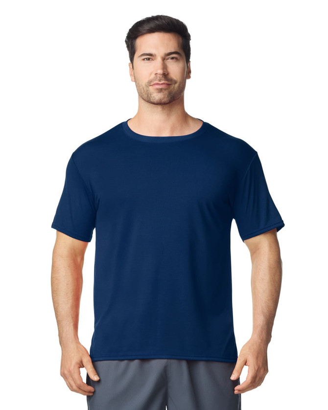 A navy Gildan Performance adult t-shirt displayed on a male model, featuring a round neckline and short sleeves.