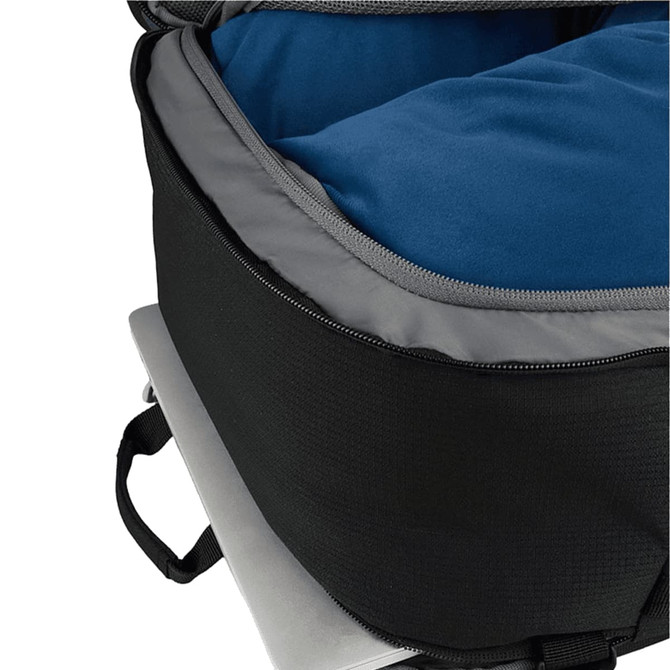 A black travel backpack interior showing a blue cushioned compartment and a silver laptop underneath.
