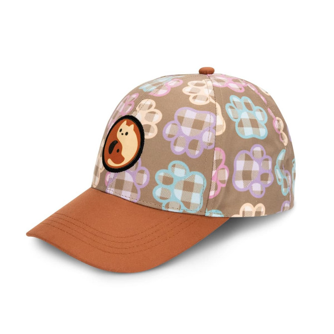 A cap featuring a full colour patch and a pattern of pastel paw prints on a beige background with a brown peak.