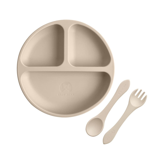 A beige silicone kids suction plate with three sections, accompanied by a spoon and fork, featuring a logo.