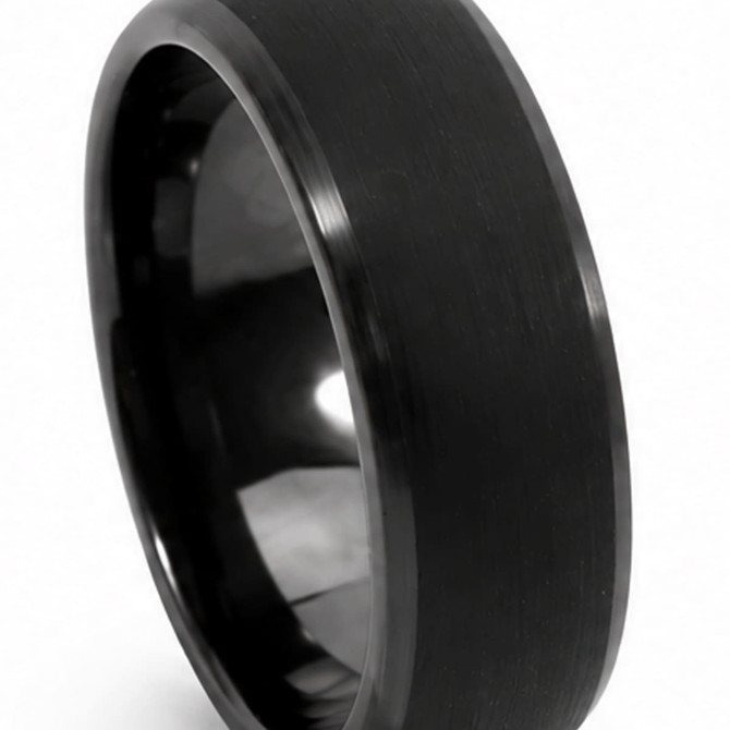 A black carbon fibre ring with a smooth, polished finish and a sleek design. It features a logo.