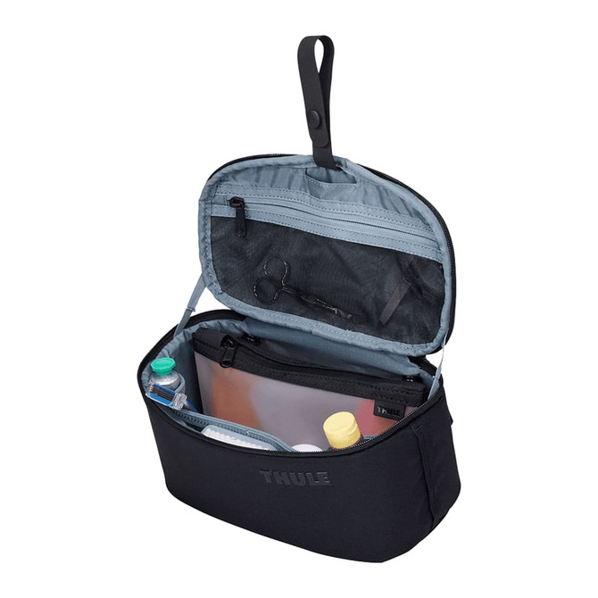 A black toiletry bag with a grey interior, featuring multiple compartments and a removable pouch.