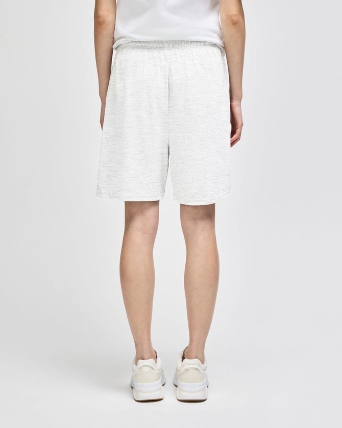 White cotton gym shorts with an elastic waistband, displayed from the back, paired with light footwear.