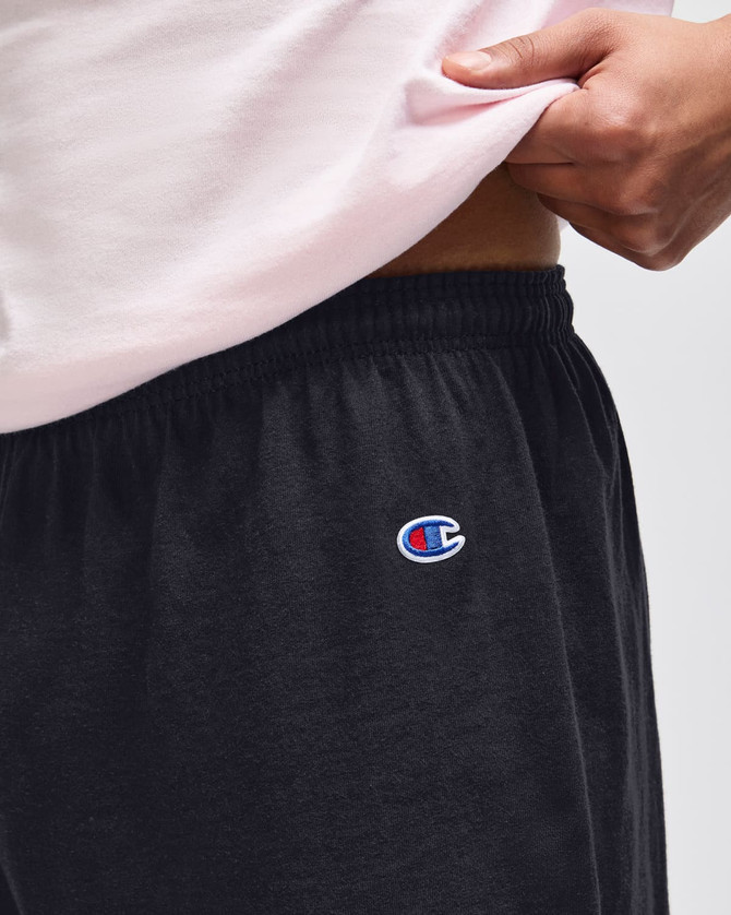 Black gym shorts with an elastic waistband and a logo on the side.