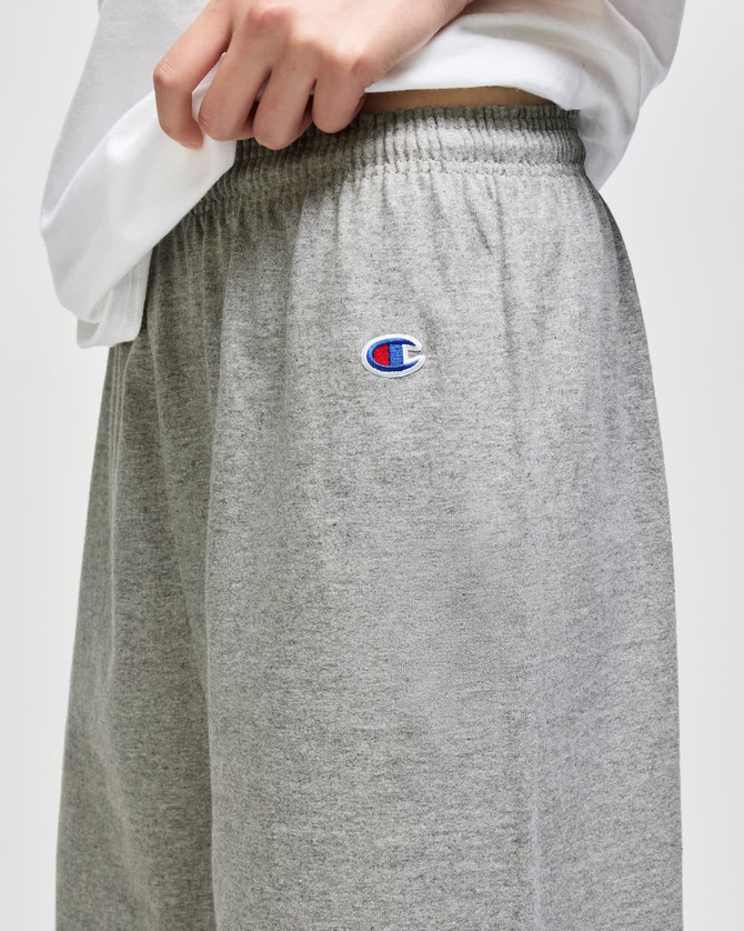 Grey cotton gym shorts with an elastic waistband and a logo on the side.