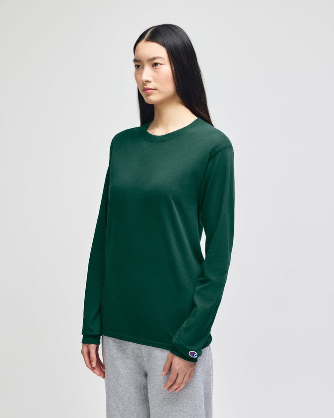 A long-sleeve t-shirt in dark green, featuring a logo on the sleeve, displayed on a model.