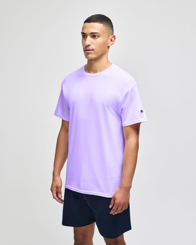 A lavender short sleeve t-shirt with a logo on the sleeve, paired with navy shorts.