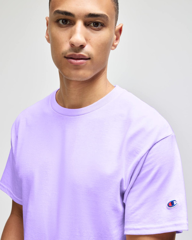 A lavender short sleeve t-shirt for adults with a logo on the sleeve.