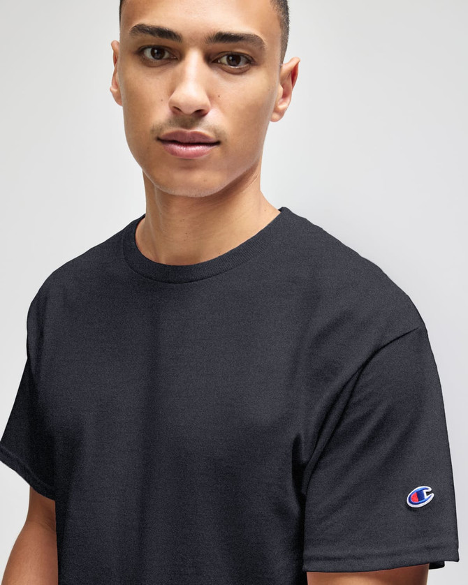 A black Champion adult jersey short sleeve T-shirt featuring a subtle logo on the sleeve.