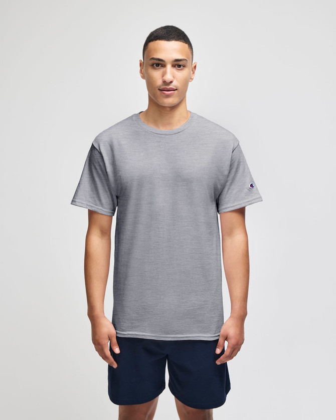 A grey short sleeve jersey t-shirt worn by a model, featuring a logo on the sleeve.