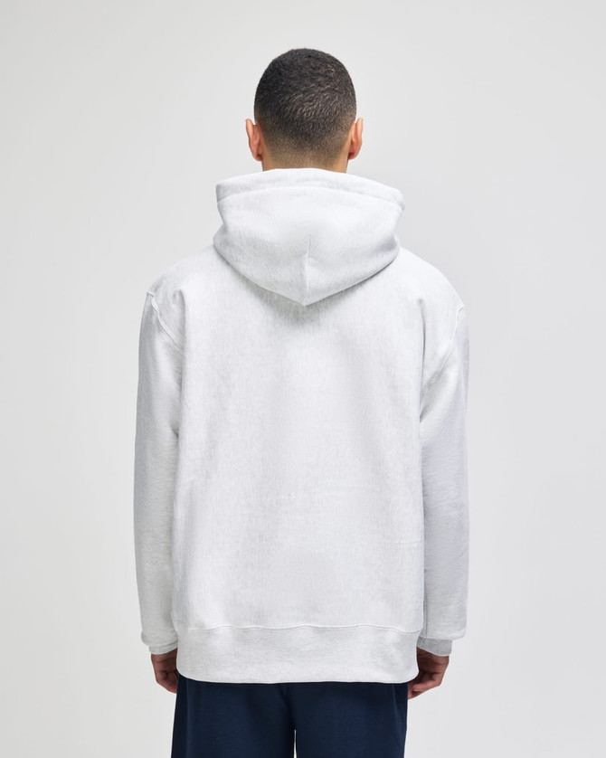 A white pullover hooded sweatshirt with a kangaroo pocket, featuring a branding logo on the back.