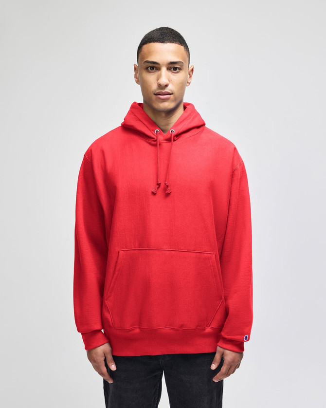 A red pullover hooded sweatshirt with a front pocket and a logo on the sleeve.